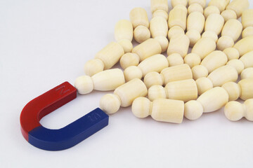 Magnet attracting many people. Control people and increase traffic concept.