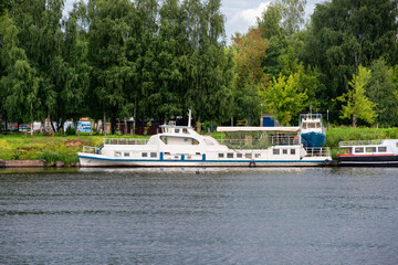 An old pleasure boat moored on the banks of the Volga River on a summer day