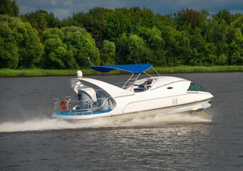 Fototapeta premium A hydrofoil boat moves at high speed along the river