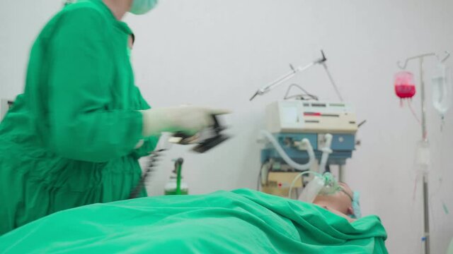 Group of Asian professional surgeons and nurses team making CPR.	