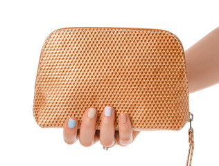 Hand with beautiful manicure holding cosmetic bag on white background