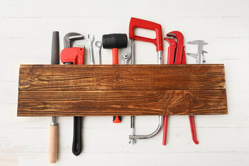 Set of construction tools on white wooden background