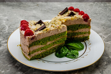 Homemade spinach cake decorated with raspberries and chocolate