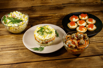 Set of various festive dishes on a wooden table