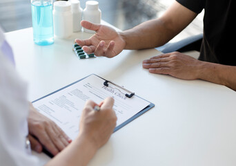 The patient is consulted with a specialist on his illness in the hospital.