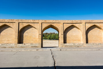 Fototapeta na wymiar Archs of Allahverdi Khan Bridge, also named Si-o-seh pol bridge, across the Zayanderud river, in Isfahan, Iran, a famous historic building in Persian History