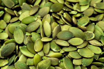 Closeup of a clump of vibrant pumpkin seeds