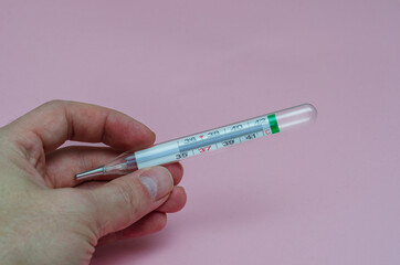 thermometer to measure the temperature of the human body in hand