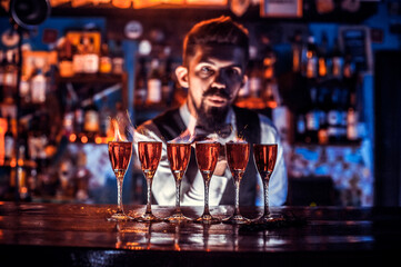 Bearded bartender formulates a cocktail at the nightclub