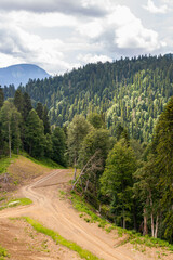 Fototapeta na wymiar Curvy dirt road down a mountain side or slope