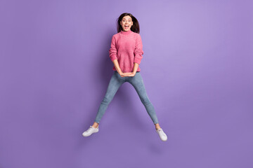 Fototapeta na wymiar Full length body size photo of jumping girl careless childish laughing isolated on bright violet color background