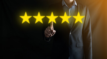 Man hand showing on five star excellent rating.pointing five star symbol to increase rating of company.Review, increase rating or ranking, evaluation and classification concept