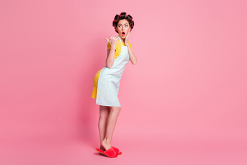 Full length body size profile side view of her she amazed housewife posing demonstrating advert copy space isolated over pink pastel color background