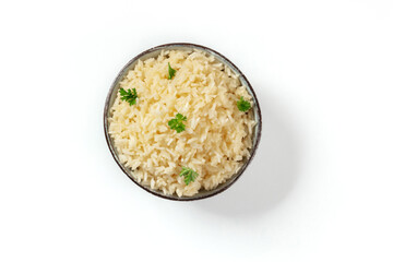 White rice, overhead shot on a white background. With fresh parsley leaves