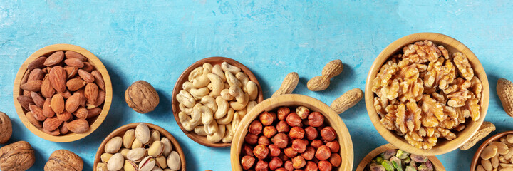 Nuts variety panorama with copy space. Many different nuts, shot from above with copy space on a...