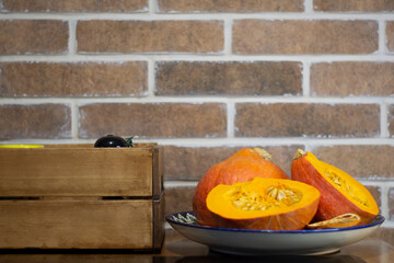 beautiful pumpkin on the background of a brick wall and a wooden box