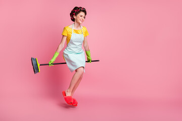 Full length body size view of attractive cheerful maid sitting besom having fun flying isolated on pink pastel color background