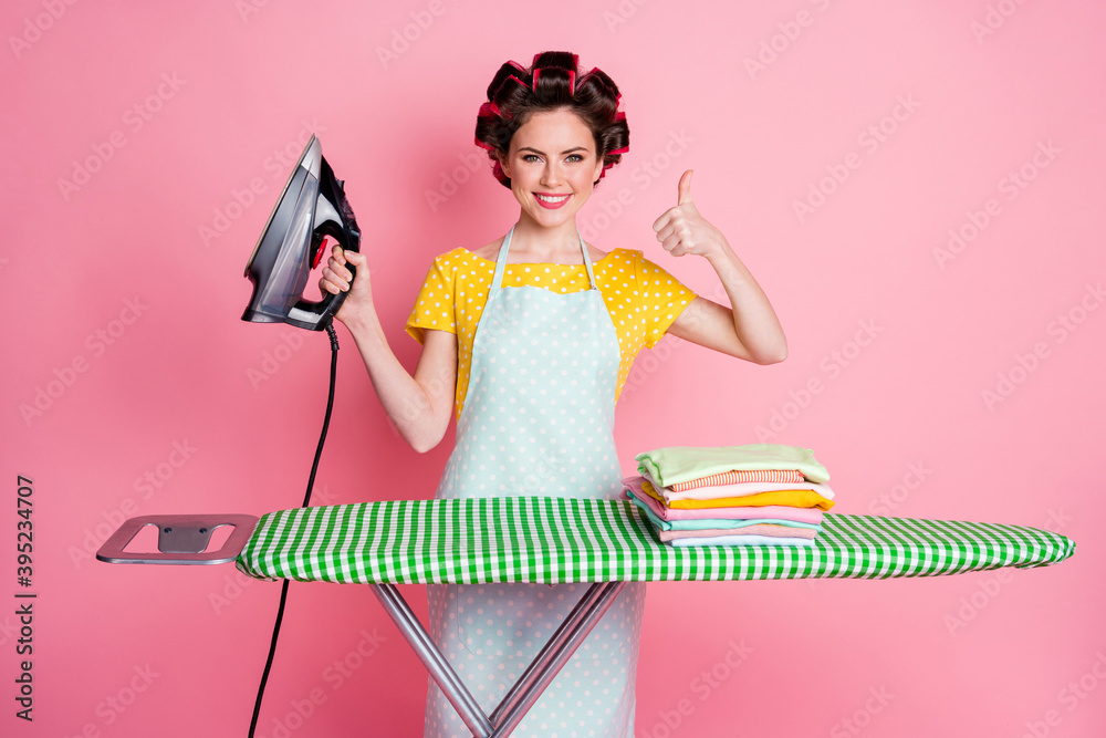 Poster positive girl iron board pile heap cloth show thumb up sign wear dotted t-shirt isolated pastel colo