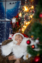 Fototapeta na wymiar Beautiful toddler child, baby boy, sleeping on Christmas eve at home