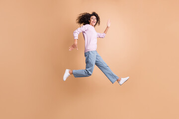 Fototapeta na wymiar Full size profile photo of energetic person run jump open mouth rush speed isolated on brown color background