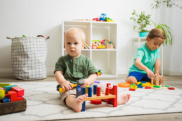 Toddler kid and baby play with educational toys