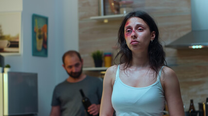 Traumatised woman looking at knife while the drunk man screaming in the back. Violent aggressive...