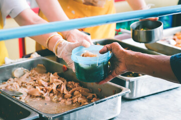The hand of the poor is given free food from volunteers : Help and Donation Concepts