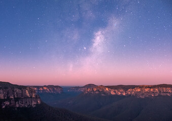 Beautiful twilight at govetts leap lookout viewing cliffs and the Gross valley NSW Australia with stars during purple hour.