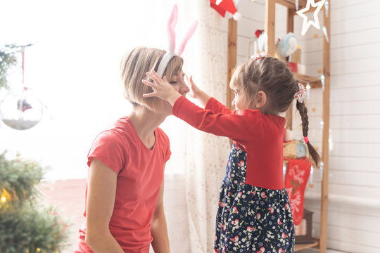 Mom And Daughter Dress Up In A Bunny Costume For Christmas