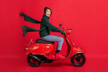 Obraz na płótnie Canvas Side profile full body photo of impressed lady drive bike journey wear boots jeans isolated on red color background