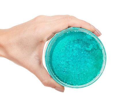 Hand with turquoise body scrab isolated on white background.