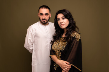 Muslim woman and man. Close up Portrait of a young arab girl and man in traditional dress. 