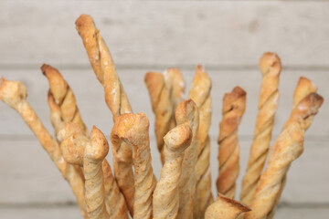 Italian grissini or salted bread sticks on a light background. Fresh italian snack. Copy space.