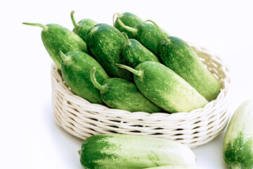 Cucumber fresh in basket and on the white table background for cooking ingredient in food healthy.