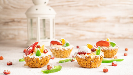 Healthy homemade sweet cakes with cottage cheese, fresh fruits and powdered sugar arround. White New Year background
