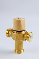 Water various supply plumbing brass thermostatic mixing valve isolated on white background.