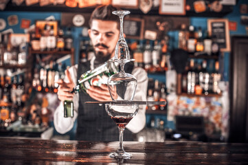Barman makes a cocktail at the saloon