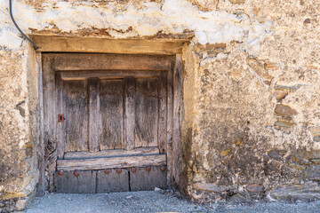 Old antique wooden door under the street level