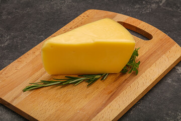 Hard cheese piece served rosemary
