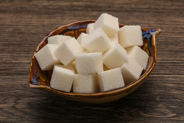 Refined white sugar cubs in the bowl