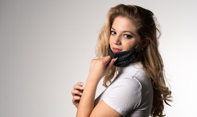 Fototapeta premium Young woman is wearing a face mask for protection against virus COVID-19 SARS, SARS-CoV, virus 2020 chinese virus 2019-nCoV