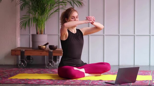 Online sport fitness yoga training workout. woman doing exercises opposite laptop at home. yoga asanas. balance between body and mental development. close up view. Slow motion nvideo. stock footage