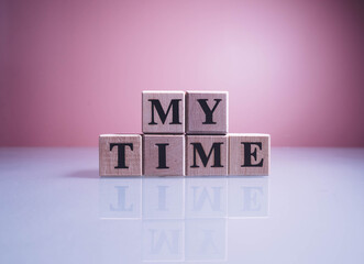 Text MY TIME on wood cube blocks. The letters MY TIME written on the cubes in black letters...