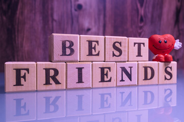 Text BEST FRIENDS on wood cube blocks. Best friends wooden cubes wallpaper. 