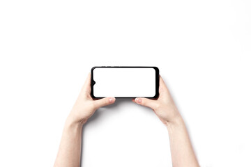 Smartphone mockup. Hand holding new black smartphone with white screen display on white background, copy space. Empty template for advertising. Cell blank mockup. Communication, social media concept.