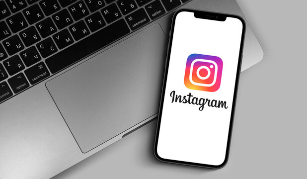 Instagram logo on the screen iPhone with MacBook closeup. Instagram is a photo-sharing app for smartphones. Moscow, Russia - November 18, 2020