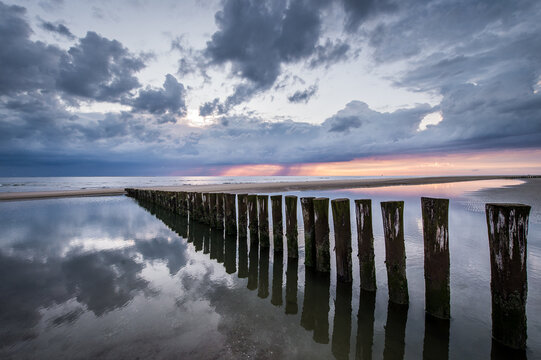 Coast of Ameland, beach poles with person