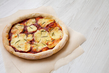 Homemade Margherita Pizza with Mozzarella and Rosemary, side view. Space for text.