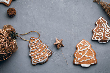 Christmas holidays ornament flat lay; Christmas card background. Gingerbread cookie, christmas toys on gray background