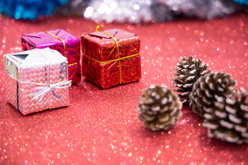 New year's and Christmas decoration in Red background, gift boxes and pine cones.